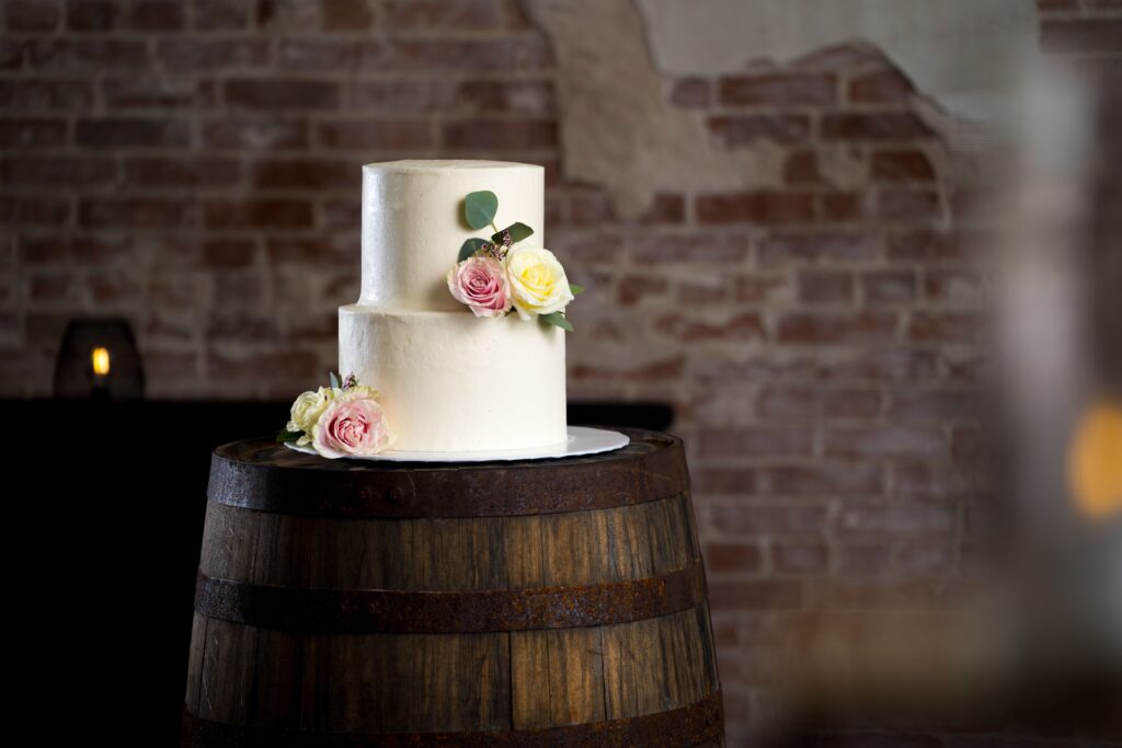 brazos baking wedding cake on wine barrel in venue near wallis tx