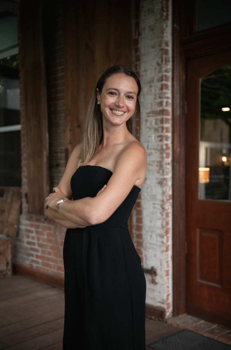 women posing on rustic porch at venue in texas